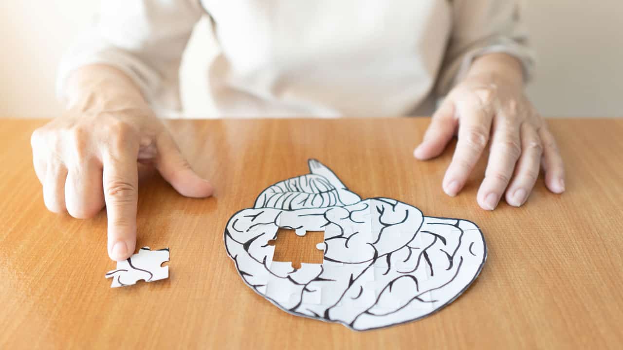 Eine Frau spielt mit einem Puzzle in Gehirnform